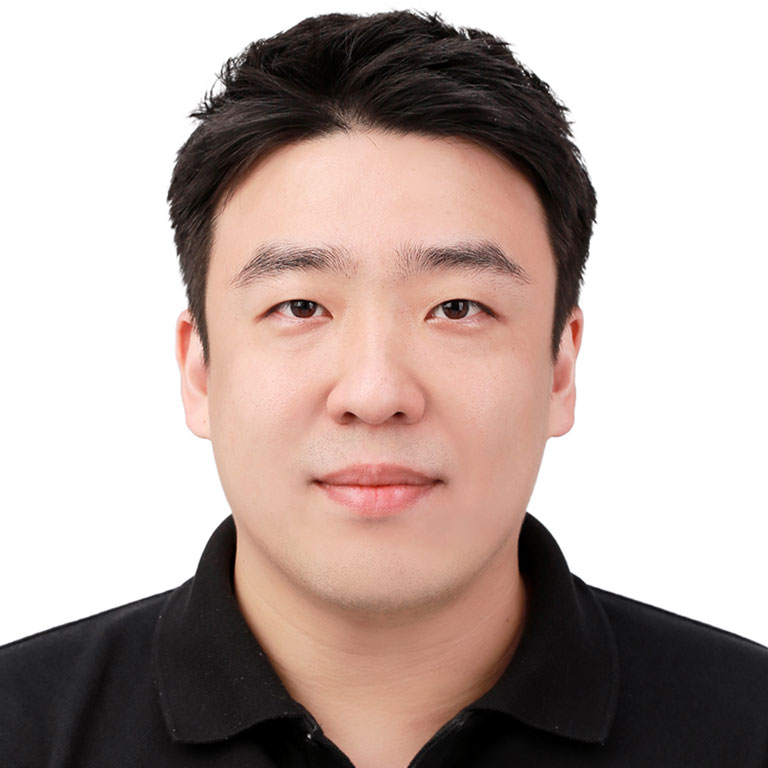 A headshot of Byung Goog Park, who wears a black polo shirt and poses against a white background.