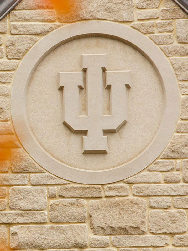 A photo of the IU trident, fashioned as a limestone seal.