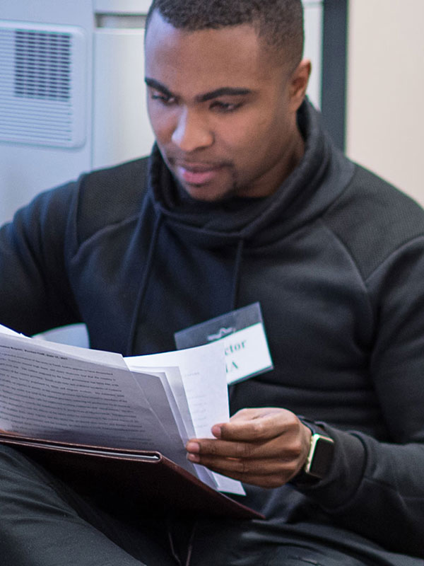 An economics undergraduate student reads a paper.