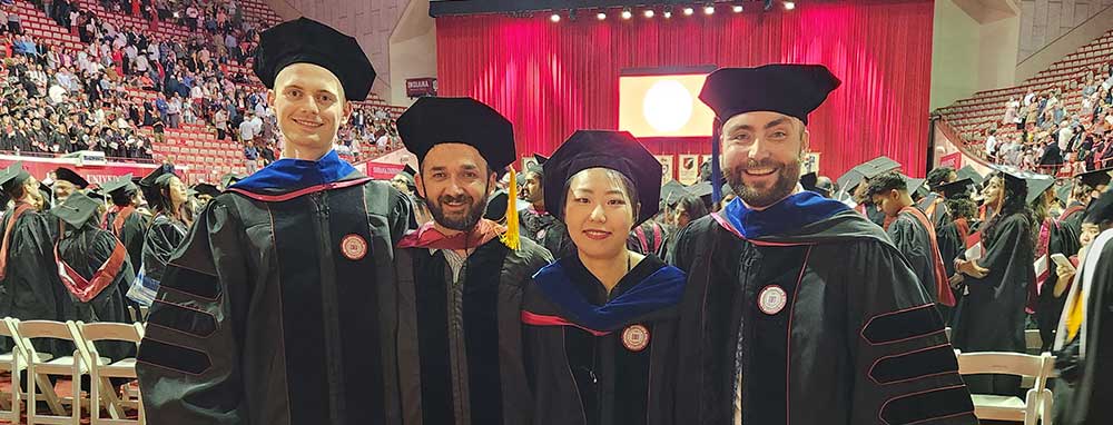 (From left) Matthew Bush, Professor Bulent Guler, Rong Fan, and David Terner pose together at commencement.
